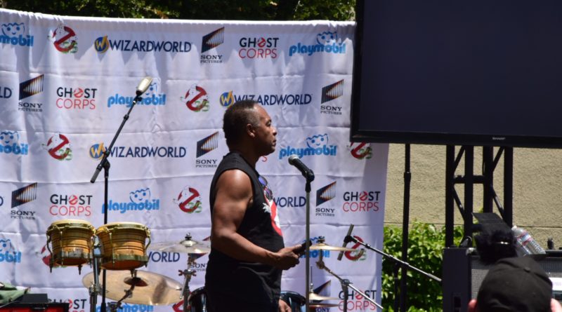 Ray Parker Jr. in sleeveless no ghost shirt setting up at Ghostbusters Fan Festvial in 2019